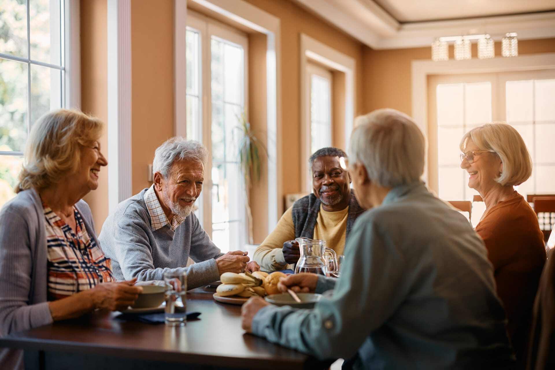 seniors-conversating-at-dinner-table